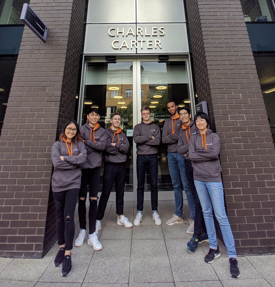 The Campus Capital team in matching hoodies outside Lancaster University Management School, 2019